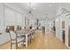 Open-concept dining area features a rustic wooden table, modern lighting, and seamless flow to the kitchen and living spaces at 273 Glenwood Se Ave # B, Atlanta, GA 30312