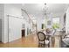 Elegant dining space showcasing a sliding barn door, wine storage, modern light fixture, and seamless access to the stairs at 273 Glenwood Se Ave # B, Atlanta, GA 30312