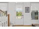 Bright entryway with natural light, showcasing a staircase, white door with sidelights, and stylish accents with wood flooring at 273 Glenwood Se Ave # B, Atlanta, GA 30312