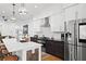 Modern kitchen featuring white cabinetry, stainless steel appliances, a spacious island with seating, and pendant lighting fixtures at 273 Glenwood Se Ave # B, Atlanta, GA 30312