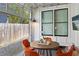Charming patio with a glass garage door, a round table, and cozy orange chairs for outdoor relaxation at 273 Glenwood Se Ave # B, Atlanta, GA 30312
