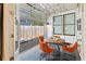 Cozy outdoor patio with a glass garage door, a round table surrounded by orange chairs, and decorative accents at 273 Glenwood Se Ave # B, Atlanta, GA 30312
