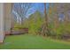 Nice backyard with a wood deck and green lawn at 7176 Ravenwood Ln, Lithonia, GA 30038