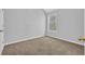 Bright bedroom with neutral carpet, light gray walls, and a window with natural light at 7176 Ravenwood Ln, Lithonia, GA 30038