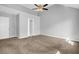 Spacious bedroom featuring neutral walls, ceiling fan, and plush carpeting at 7176 Ravenwood Ln, Lithonia, GA 30038