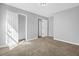 Bedroom with light gray walls, neutral carpet and a double door closet at 7176 Ravenwood Ln, Lithonia, GA 30038
