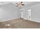 Large bedroom features neutral walls, ceiling fan, carpet and an ensuite bathroom at 7176 Ravenwood Ln, Lithonia, GA 30038