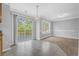Dining area features sliding glass doors to deck, great natural light, and carpet at 7176 Ravenwood Ln, Lithonia, GA 30038