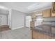 Well-lit kitchen features wooden cabinets, white appliances, and neutral countertops at 7176 Ravenwood Ln, Lithonia, GA 30038