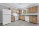 Kitchen equipped with white appliances and wood cabinets, offering a practical design at 7176 Ravenwood Ln, Lithonia, GA 30038