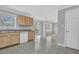 Bright kitchen with wood cabinets, white dishwasher and sink beneath a window at 7176 Ravenwood Ln, Lithonia, GA 30038