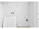 Bright laundry room with white walls and essential hookups at 7176 Ravenwood Ln, Lithonia, GA 30038