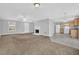 Open-concept living space with a fireplace, adjacent to a functional kitchen area at 7176 Ravenwood Ln, Lithonia, GA 30038