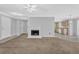 Comfortable living area featuring a cozy fireplace that flows into a well-lit kitchen at 7176 Ravenwood Ln, Lithonia, GA 30038