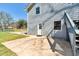 Flat, grassy backyard with a gray home exterior, a concrete patio, and a fenced-in yard at 3582 Ontario Ct, Buford, GA 30519