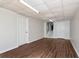 Spacious basement area with wood floors, white walls, and access to a stairway at 3582 Ontario Ct, Buford, GA 30519