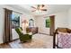 Bright bedroom with a rocking chair, crib, and windows, creating a serene Bedroom space at 3582 Ontario Ct, Buford, GA 30519
