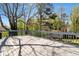 Spacious wooden deck with gray railing, offers great outdoor living surrounded by mature trees at 3582 Ontario Ct, Buford, GA 30519
