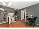 Transitional space showcases hardwood floors connecting dining room and stairway to second floor at 3582 Ontario Ct, Buford, GA 30519