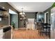 Transitional space showcases hardwood floors connecting kitchen and dining room and stairway to second floor at 3582 Ontario Ct, Buford, GA 30519
