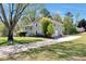 Side view of a grey two-story home with a long driveway leading to a one car garage at 3582 Ontario Ct, Buford, GA 30519