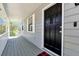 Covered front porch showcasing a modern black door, clean lines and windows at 3582 Ontario Ct, Buford, GA 30519