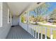 Spacious covered porch with white railings offering a lovely view of the neighborhood at 3582 Ontario Ct, Buford, GA 30519