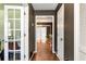Entry hallway featuring hardwood floors, white trim, and a clear view to the living room at 3582 Ontario Ct, Buford, GA 30519