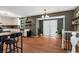 Open floor plan with white cabinets, a kitchen table and a large set of French doors letting in natural light at 3582 Ontario Ct, Buford, GA 30519