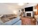 Comfortable living room featuring a fireplace, large screen TV, plush couches and staircase access at 3582 Ontario Ct, Buford, GA 30519