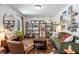 Inviting living room featuring a stylish green sofa, wooden furniture, and charming decor and artwork at 3582 Ontario Ct, Buford, GA 30519
