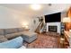 Comfortable living room featuring a fireplace, large screen TV, plush couches and staircase access at 3582 Ontario Ct, Buford, GA 30519