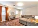 Comfortable living room with an oversized plush couch, decor shelves and lots of natural light at 3582 Ontario Ct, Buford, GA 30519