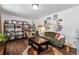 Bright living room features warm wood floors, stylish furniture, curated book shelves, and unique decor at 3582 Ontario Ct, Buford, GA 30519