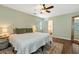 Light and airy main bedroom with pale green walls, a queen bed and an ensuite bathroom at 3582 Ontario Ct, Buford, GA 30519