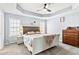 Spacious main bedroom with a tray ceiling, ample lighting, and a comfortable king-size bed at 38 Wayfaring Ct, Rockmart, GA 30153