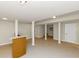Finished basement with neutral tones, pillars, and a bar area at 2480 Miriam Ln, Decatur, GA 30032
