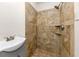 Tiled walk-in shower with modern vanity and bright fixtures at 2480 Miriam Ln, Decatur, GA 30032