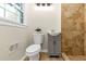 Updated bathroom features a modern vanity, toilet, and tiled walk-in shower with window at 2480 Miriam Ln, Decatur, GA 30032