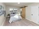 Cozy bedroom with natural light, light wood floors, and a unique sliding barn door at 2480 Miriam Ln, Decatur, GA 30032