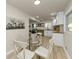 Charming dining area with a round glass table and white chairs, adjacent to the kitchen at 2480 Miriam Ln, Decatur, GA 30032