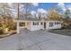 Well-maintained single-story home with spacious driveway, carport, and charming front facade at 2480 Miriam Ln, Decatur, GA 30032