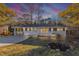 Charming single-story home featuring a well-manicured front yard and a convenient carport on a spacious lot at 2480 Miriam Ln, Decatur, GA 30032