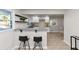 Bright kitchen with stainless steel sink, counter seating, and modern white cabinetry at 2480 Miriam Ln, Decatur, GA 30032