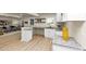 Open-concept kitchen with bar seating, stone countertops, and seamless flow to the living area at 2480 Miriam Ln, Decatur, GA 30032