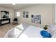 Bright bedroom with light floors, console table, contemporary art and comfortable sitting area at 2480 Miriam Ln, Decatur, GA 30032