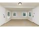A room with neutral paint, windows, two doorways and neutral tile flooring at 2480 Miriam Ln, Decatur, GA 30032