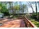 Spacious stained deck with wooden railings overlooking the lush green backyard and mature trees at 2666 Frontier Trl, Atlanta, GA 30341