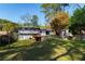 Beautiful backyard with tiered landscaping, mature trees, detached storage shed, deck, and a partial view of the home at 2666 Frontier Trl, Atlanta, GA 30341