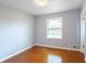 Bright bedroom featuring a large window and hardwood floors at 2666 Frontier Trl, Atlanta, GA 30341